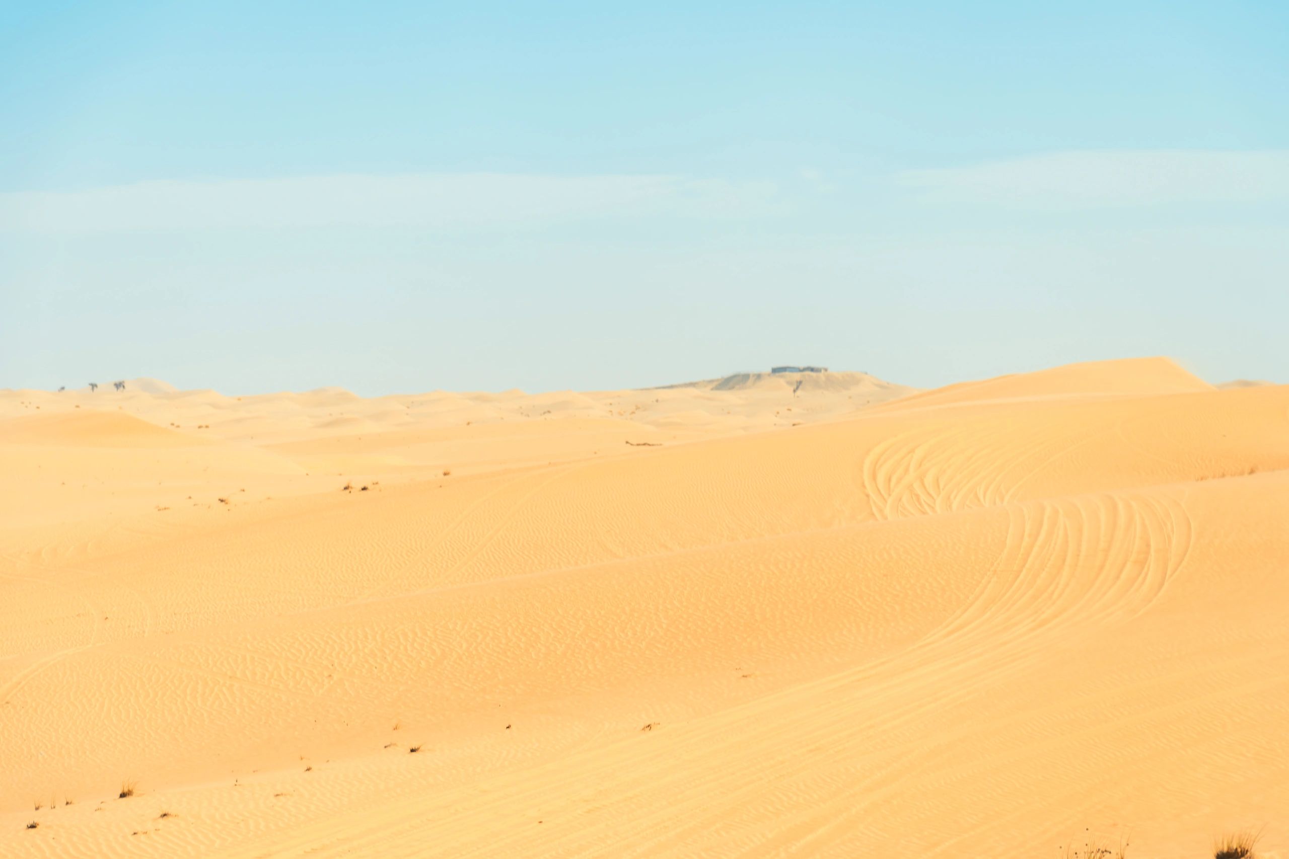 Desert dunes under a clear blue sky