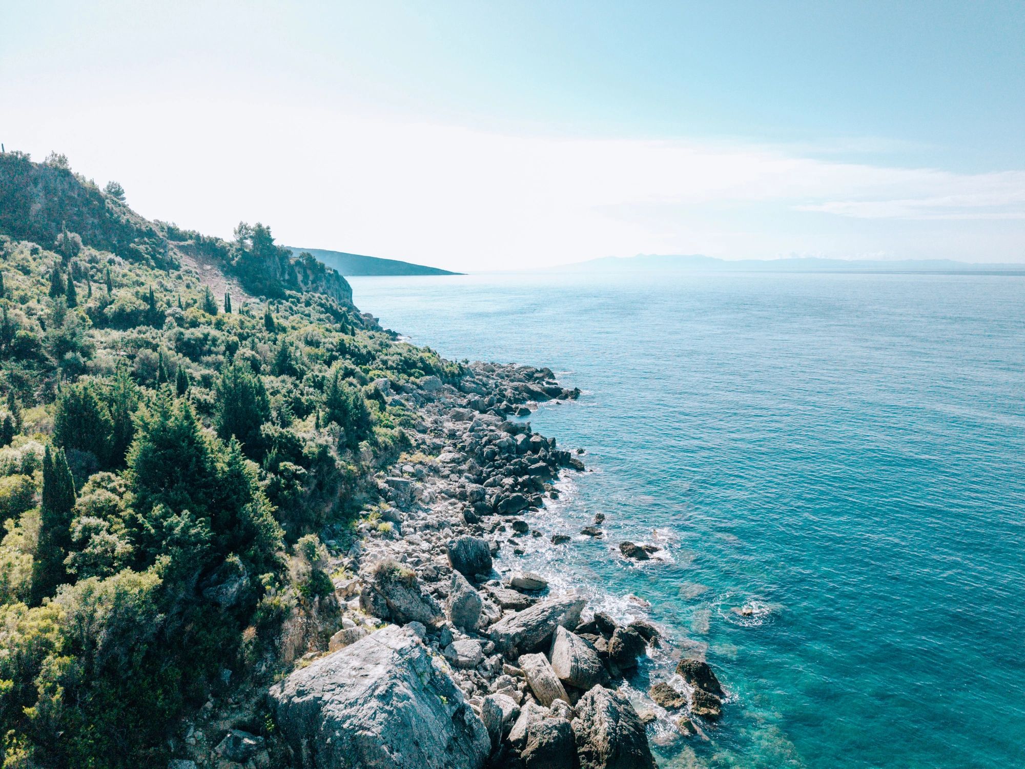Rocky coastal cliffs with clear blue water