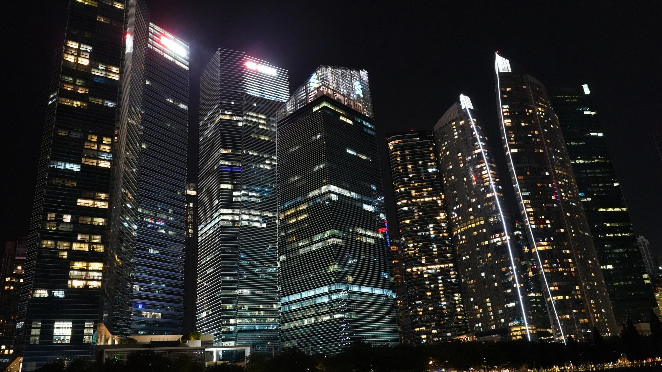 Singapore skyline at night with illuminated skyscrapers